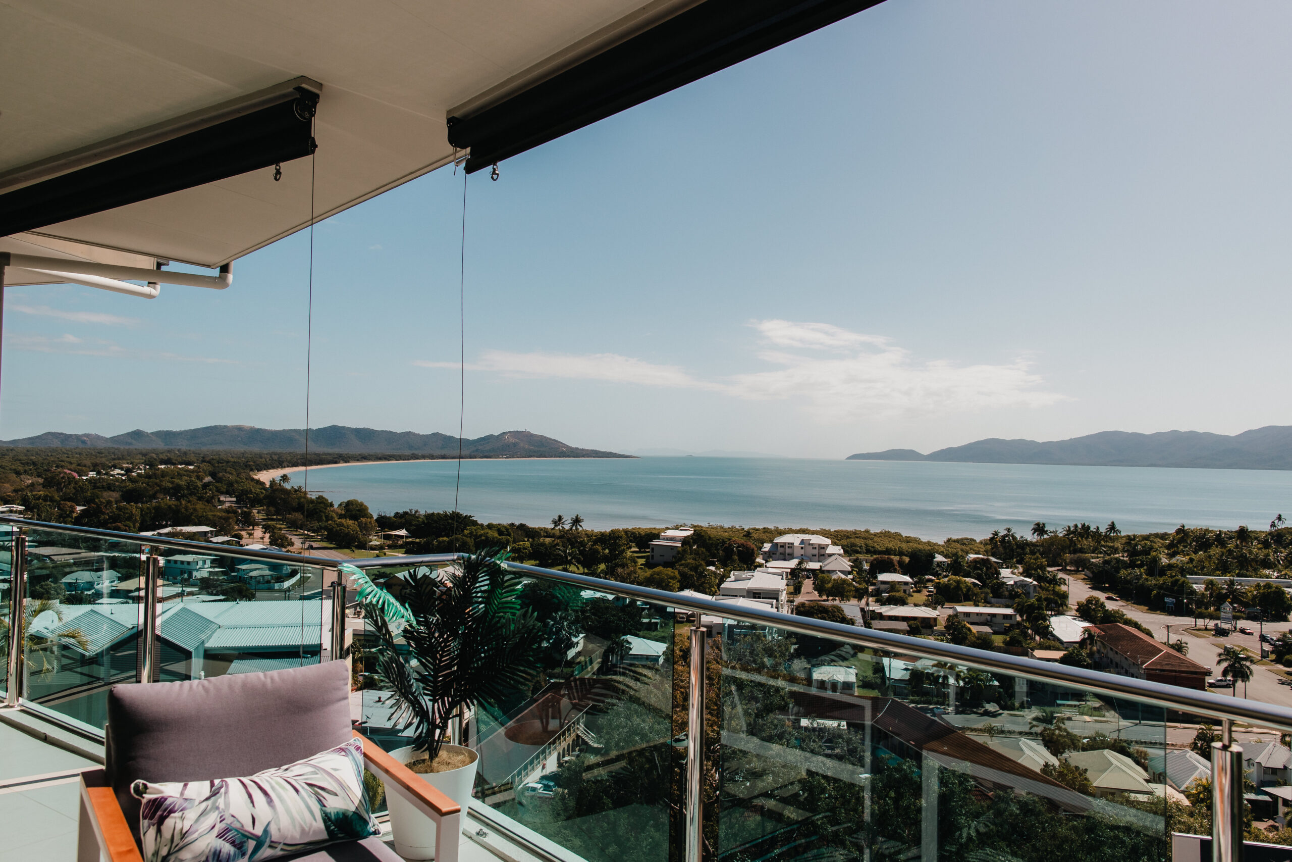 Panoramic views of the ocean from a balcony, Cape Pallarenda and Magnetic Island in the distance.